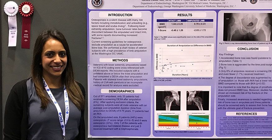 Fellow standing with research project presentation